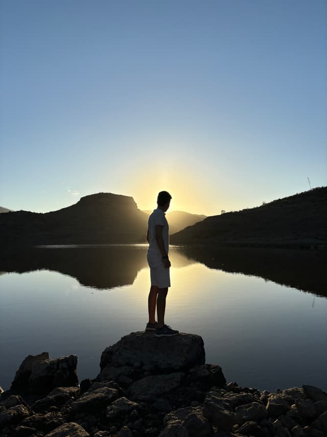 Photo of Chamil watching the sunset.